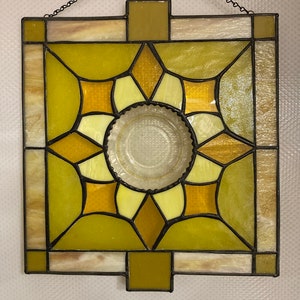 Stained Glass Panel with a yellow depression glass saucer in the Center