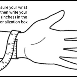 May include: A black and white line drawing of a hand with a measuring tape around the wrist. The text "Measure your wrist and then write your size (inches) in the personalization box" is above the hand.
