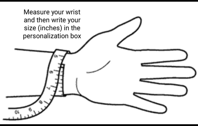 May include: A black and white line drawing of a hand with a measuring tape around the wrist. The text "Measure your wrist and then write your size (inches) in the personalization box" is above the hand.