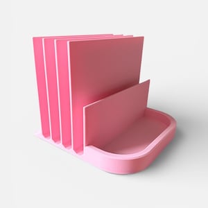 May include: A pink desk organizer with a tray and vertical dividers. The organizer has a rectangular base with a curved front and a series of upright dividers to hold papers or files. The color is a solid, soft pink.