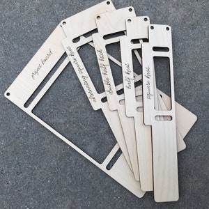 May include: A set of five light-colored wooden macrame tools with laser-engraved text. The pieces are labeled project board, alternating square knot, double half hitch, half knot, and square knot. Each tool features rectangular cutouts and holes.