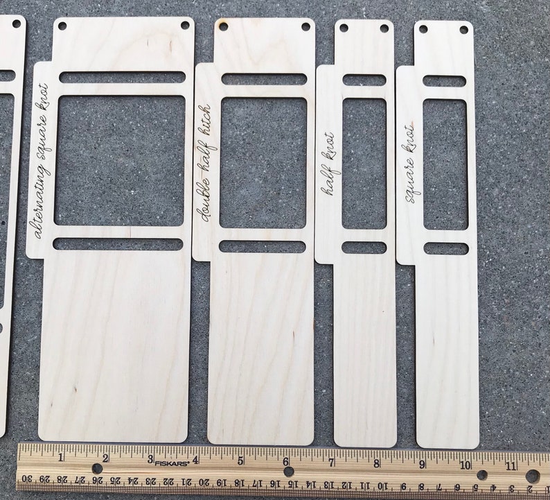 May include: Four light-colored wooden macrame knotting boards with cutouts and engraved text labels including alternating square knot, double half hitch, half knot, and square knot, positioned above a ruler measuring up to 11 inches.