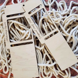 May include: Two light-colored wooden macrame knotting tools with rectangular cutouts. One tool is engraved with the text Alternating Square and the other with Diagonal Half Hitch. Both tools feature small circular holes at the top edge.