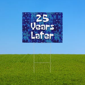 May include: A blue and green yard sign with a white background and the text "25 Years Later" in a white, cartoon-style font.