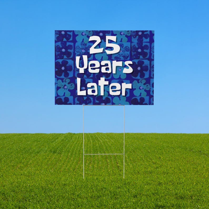 May include: A blue and green yard sign with a white background and the text "25 Years Later" in a white, cartoon-style font.