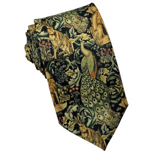 May include: A necktie featuring a dark black background with a repeating pattern of brown rabbits, a green and gold peacock, and various floral elements including small red berries and green foliage in a dense, intricate botanical arrangement.