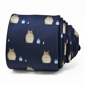 May include: Navy blue necktie featuring a repeating pattern of cartoon characters. The tie is rolled up, showcasing the detailed design. The characters are in shades of beige, blue, and white, set against a dark blue background. A stylish accessory.