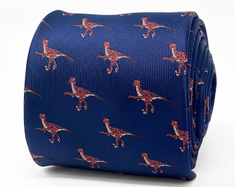 May include: A dark blue silk tie with a repeating pattern of red velociraptors.
