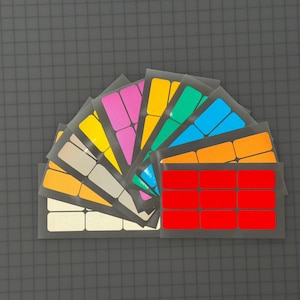 May include: A set of nine sheets of colorful labels, each sheet containing nine rectangular labels. The labels are arranged in a fan shape, with the red labels at the bottom and the yellow labels at the top. The labels are perfect for organizing and labeling items.