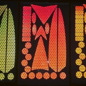 May include: Three sheets of reflective safety stickers in yellow, orange, and red. Each sheet features a variety of shapes, including triangles, circles, and ovals. The stickers are designed to be used on bicycles, motorcycles, and other vehicles to increase visibility.
