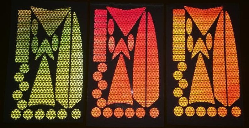 May include: Three sheets of reflective safety stickers in yellow, orange, and red. Each sheet features a variety of shapes, including triangles, circles, and ovals. The stickers are designed to be used on bicycles, motorcycles, and other vehicles to increase visibility.