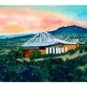 May include: Watercolor painting of a white bridge with a large, curved roof over a building. The bridge is set against a backdrop of green hills and a blue sky with pink and orange clouds.