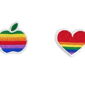 May include: Two embroidered patches: an apple and a heart. The apple patch features a green stem and rainbow-colored stripes. The heart patch is red with rainbow stripes. Both patches have a white border and are on a white background.