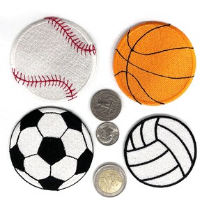May include: Four embroidered sports patches: a baseball, basketball, football, and volleyball. The baseball is white with red stitching. The basketball is orange with black lines. The football is black and white. The volleyball is white with black lines.