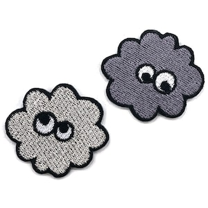 May include: Two embroidered patches in the shape of fluffy clouds with wide, googly eyes. One patch is light gray, the other is dark gray. Both have black outlines and white and black eyes. These patches are perfect for adding to clothing or accessories.