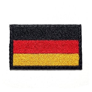 May include: Embroidered patch featuring the German flag. The rectangular patch displays three horizontal stripes in black, red, and gold. The flag is bordered by a black edge and is set against a white background.