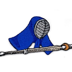 May include: Embroidered patch featuring a blue kendo helmet and a bamboo sword. The helmet has white stitching and the sword has brown and orange accents. The patch is on a white background.