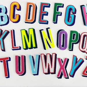 May include: Embroidered alphabet patches in various colors, including yellow, orange, blue, green, pink, and purple. Each letter has a 3D effect with a dark blue shadow. The patches are arranged on a white background.