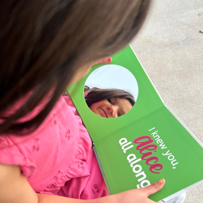 Child looking in mirror of personalized board book I Knew You Before You Were Born