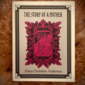 May include: The Story of a Mother by Hans Christian Andersen. A black and white illustration of a mother and child in a pink and black ornate frame.