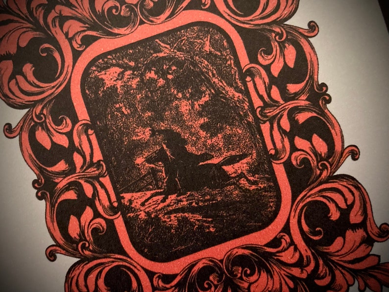 K&ouml;nnte beinhalten: Gerahmte Illustration in Schwarz und Rot. Das zentrale Bild zeigt eine Silhouette einer Person auf einem Pferd in einer Waldlandschaft. Der Rahmen hat aufwendige, wirbelnde Blumenmuster, die ein Vintage-Feeling erzeugen. Das Design ist dekorativ.