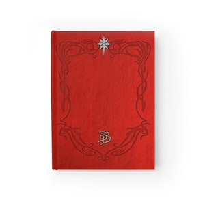 May include: Red leather-bound journal with an ornate silver star and a silver monogram "BB" on the front cover.