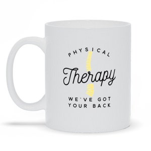 May include: White ceramic mug with a black and yellow design. The mug says "Physical Therapy We've Got Your Back".
