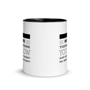 May include: White ceramic coffee mug with a black interior. The mug features black text on both sides. One side reads "Where do wishes go?" and the other side reads "What things make you..."