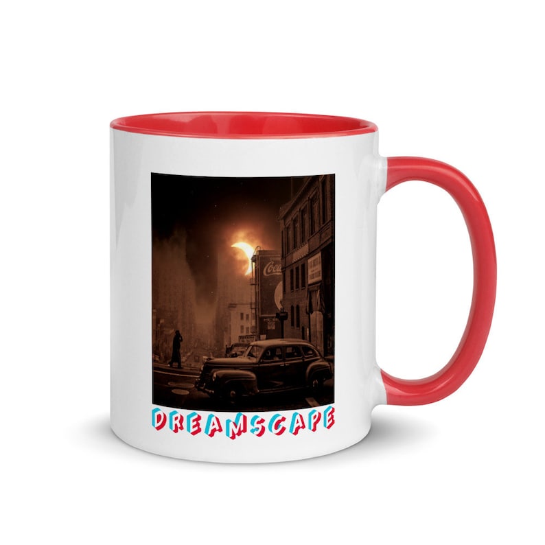 May include: White ceramic mug with a red interior and handle. The mug features a sepia-toned image of a vintage car on a city street with a dramatic sky. The word "DREAMSCAPE" is printed in colorful letters.