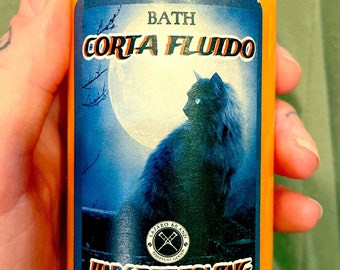 May include: A small orange bottle with a gold lid and a blue label. The label has a black cat silhouette, a full moon, and the text "BATH CORTA FLUIDO JINX REMOVING SHAKE WELL BEFORE USE. FOR EXTERNAL USE ONLY 8 fl oz. (236ml)"