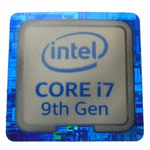 May include: A close-up of a blue and silver Intel Core i7 9th Gen processor. The processor has a blue and silver border and the text "Intel Core i7 9th Gen" is printed on the front.