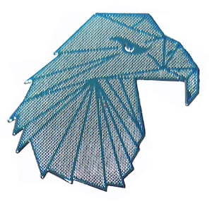 May include: A metallic blue embroidered patch in the shape of an eagle head. The design features a geometric, faceted pattern created with stitched lines that form the beak, eye, and feathers, giving the bird a sharp, angular appearance.