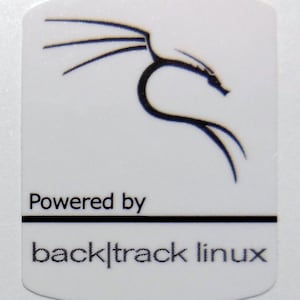May include: White sticker with a black dragon logo and the text "Powered by backtrack linux".