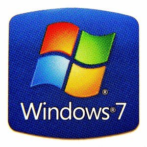 May include: A blue sticker with the Windows 7 logo. The logo features a four-pane window design in red, yellow, green, and blue. The text "Windows 7" is written in white below the logo.