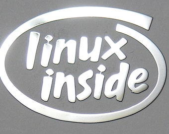 May include: A silver oval sticker with the text "linux inside" in white lettering.