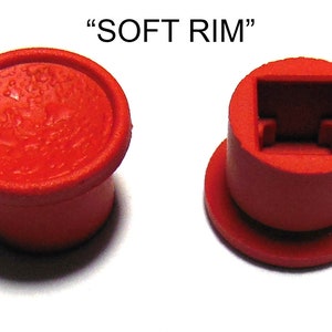 May include: Two red plastic keyboard keycaps, one with a smooth top and the other with a square cutout. The text "SOFT RIM" is printed above the keycaps.