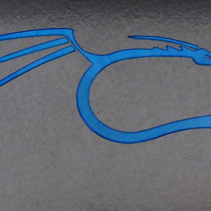 May include: A blue stylized dragon logo with wings and a tail. The dragon is facing right and has a sharp snout.