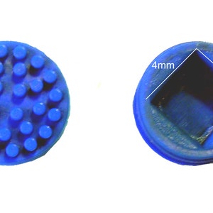 May include: Blue rubber button with a square indentation in the center. The indentation measures 4 mm by 4 mm.