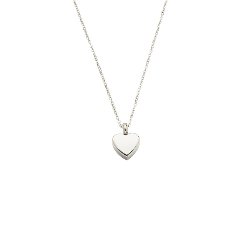 May include: A silver heart-shaped pendant necklace. The pendant is smooth and has a shiny finish.