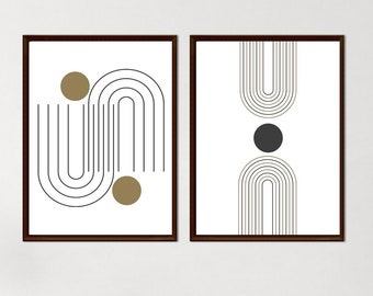 May include: Two framed abstract art prints. One features a black and gold design with curved lines and circles on a white background. The other has a similar design with a black circle and curved lines. The frames are dark brown.