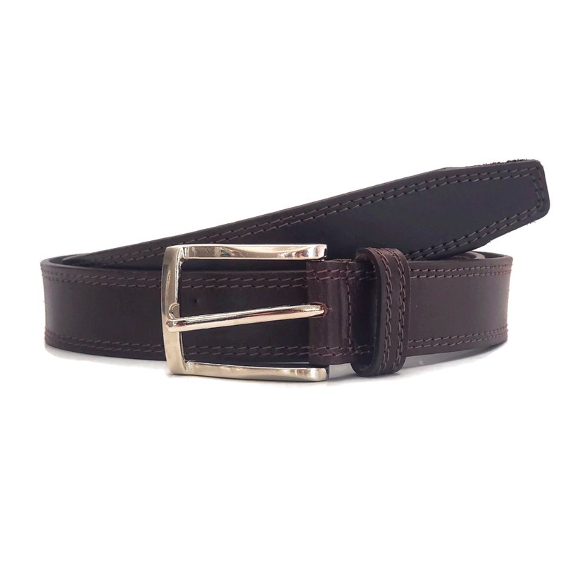 May include: A brown leather belt with a silver buckle. The belt has a stitched edge and a smooth finish.