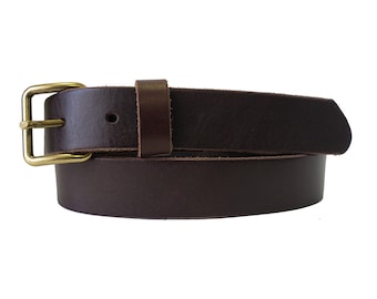 May include: A brown leather belt with a brass buckle. The belt is rolled up and the buckle is visible.
