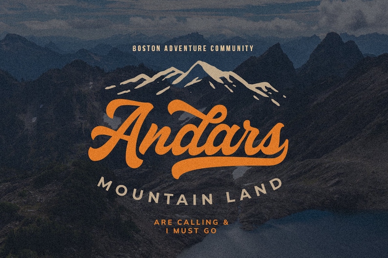May include: A vintage-style logo with the text "Andars Mountain Land" in orange script font. The logo is set against a backdrop of a mountain range with snow-capped peaks. The text "Boston Adventure Community" appears above the logo, and the text "Are Calling & I Must Go" appears below the logo.