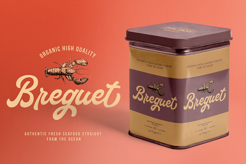 May include: A brown metal tin with a gold label. The label has the text "Breguet" in a stylized font and a drawing of a lobster. The text "Authentic Fresh Seafood Straight From The Ocean" is also on the label.