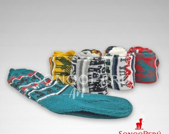 May include: A selection of colourful, knitted socks. One sock is teal with a geometric pattern. Rolled socks in yellow, grey, black, white, and red display various patterns. The socks are likely handmade and suitable for cold weather.