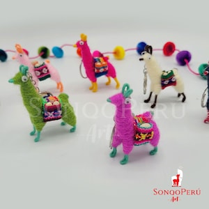 Puede incluir: Un conjunto de llaveros de llama de colores hechos de fieltro. Cada llavero presenta una llama con una silla de montar y un pequeño llavero. Las llamas son de varios colores, incluyendo verde, rosa, blanco y amarillo.