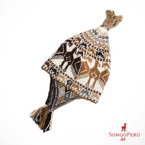 May include: A brown, white and black knitted hat with a long tassel. The hat features a geometric pattern with stylised birds.
