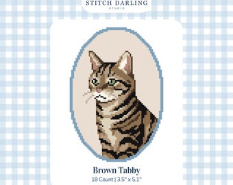 May include: A digital cross stitch pattern featuring a brown tabby cat portrait inside an oval frame. The text reads Stitch Darling Studio, Brown Tabby, 18 Count, 3.5 inches by 5.1 inches, and Digital Stitch Chart. The design uses a light blue gingham background.
