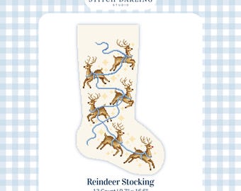 May include: A cream-colored Christmas stocking cross-stitch pattern featuring five brown reindeer connected by a light blue ribbon, accented with small gold stars. The text reads Stitch Darling Studio, Reindeer Stocking, 13 Count, 9.7 inches by 16.6 inches.