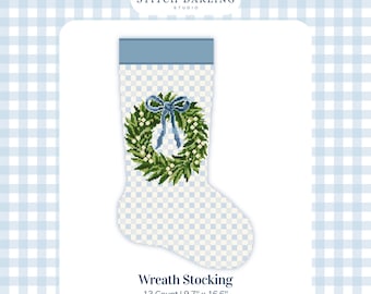 May include: A digital cross stitch chart for a Christmas stocking featuring a light blue and white gingham pattern, a solid blue cuff, and a central green wreath with white berries and a blue bow. The text reads Stitch Darling Studio, Wreath Stocking, 13 Count, 9.7 inches by 16.6 inches.